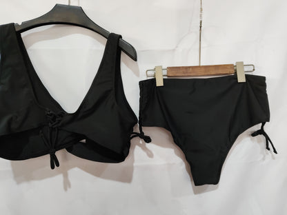 Black bikini set on hangers against a white background