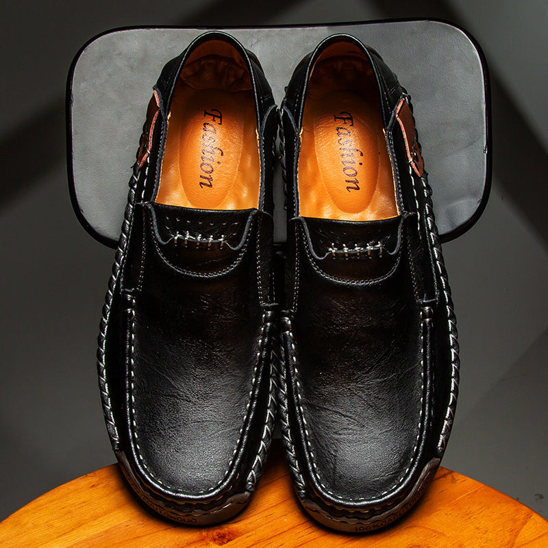 Black leather loafers with 'Fashion' branding on a dark background