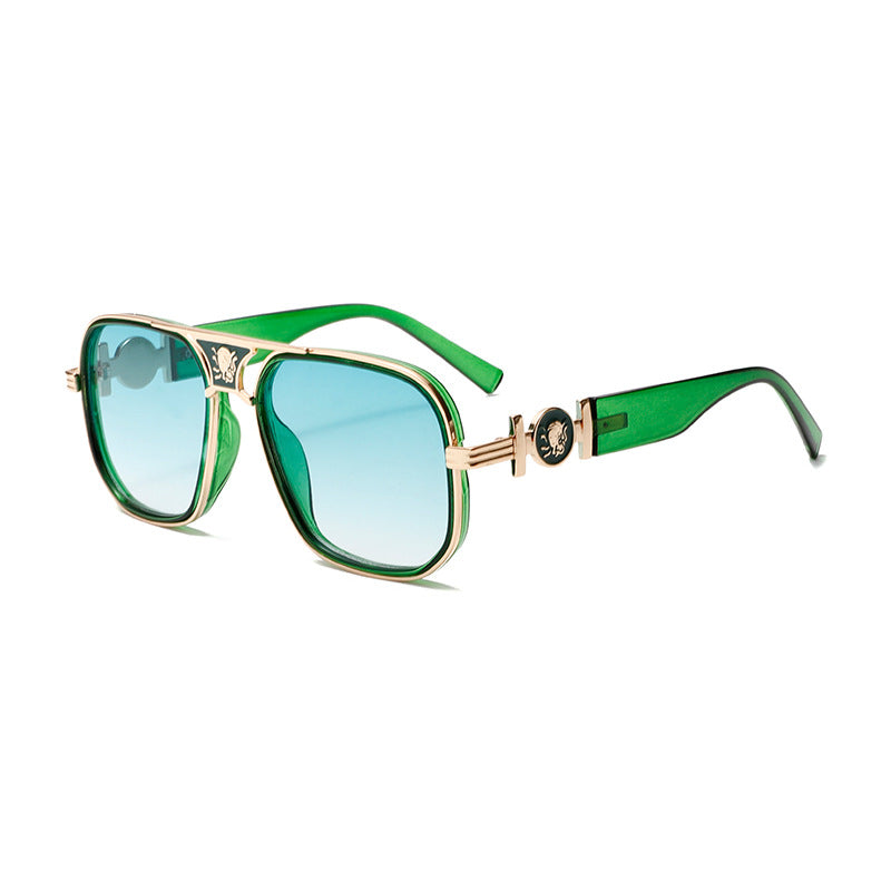 Sunglasses with green and gold frame on a white background
