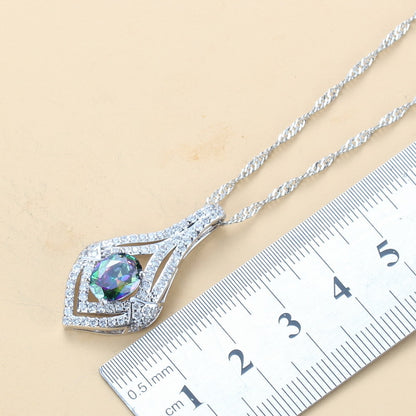 Silver necklace with a colorful pendant on a ruler for scale