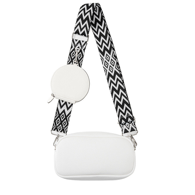 White cylindrical product with a black and white zigzag strap on a white background