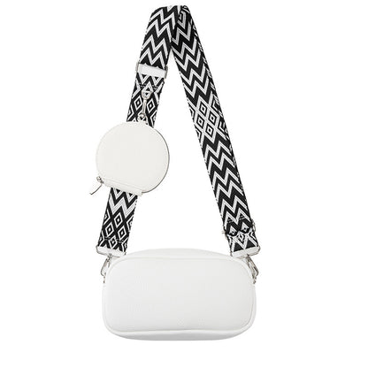 White cylindrical product with a black and white zigzag strap on a white background