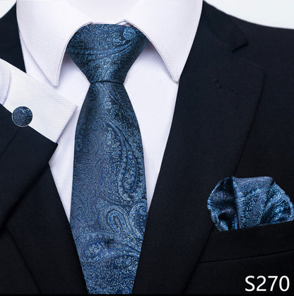 Blue paisley tie and pocket square set with black suit and white shirt