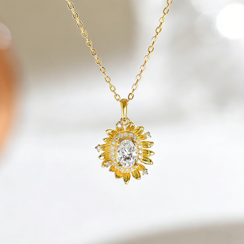 Gold necklace with a diamond pendant on a blurred background