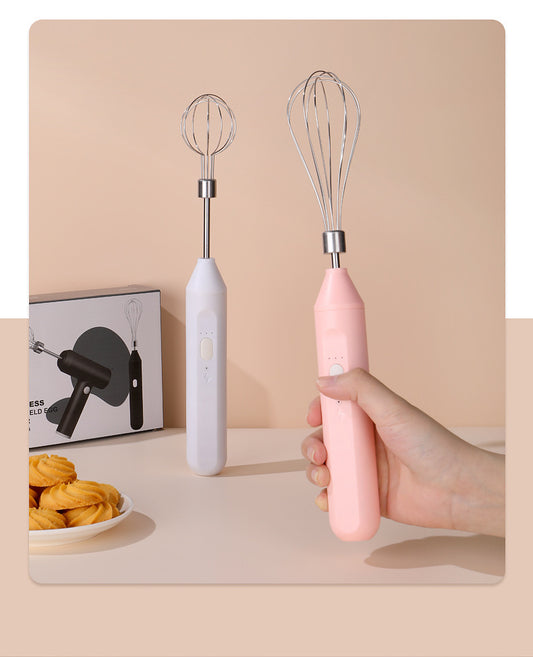 Pink and white handheld mixers with whisk attachments on a beige background