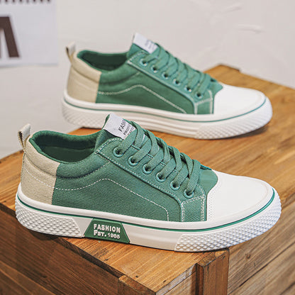 Green and beige sneakers on a wooden surface with a blurred background