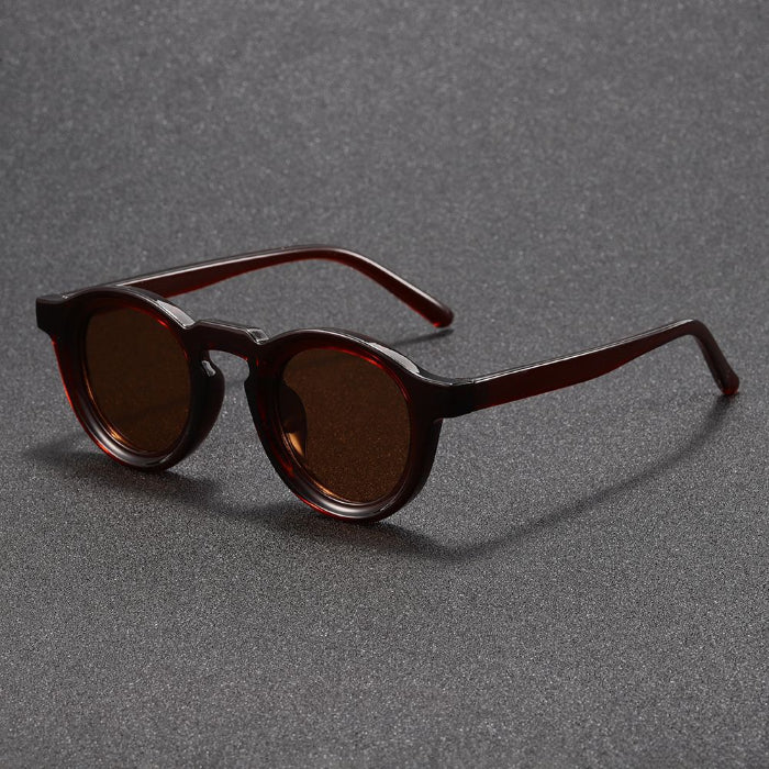Brown sunglasses on a gray textured background