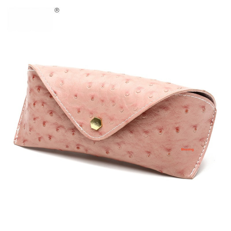 Pink textured clutch bag with a gold clasp on a white background