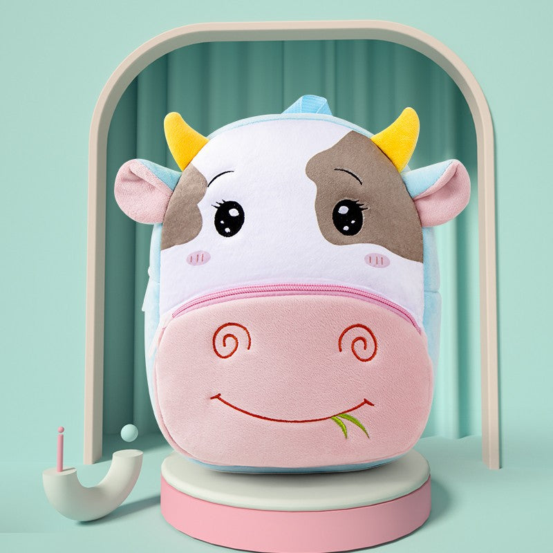 Plush kids backpack shaped like a smiling cow with pink belly and zipper
