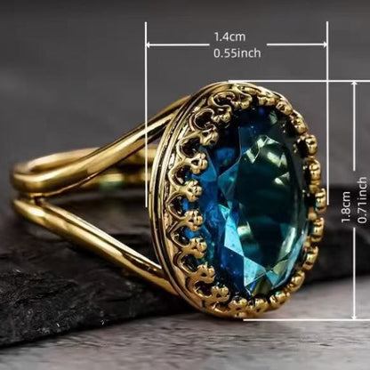 Gold ring with a blue gemstone and measurements on a dark background