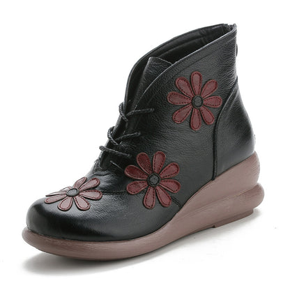 Black ankle boot with red floral patterns on a white background