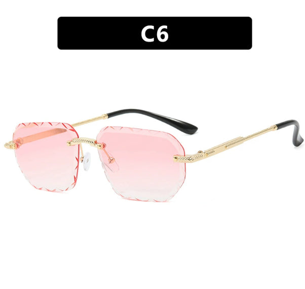 Sunglasses with pink lenses and gold frames on a white background