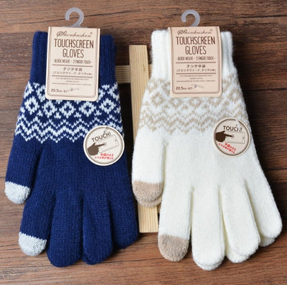 Pair of touchscreen gloves, one blue and white patterned, one beige and brown patterned, on a wooden surface.