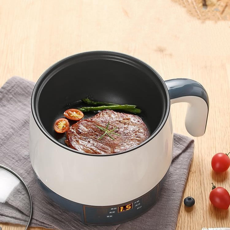 Small electric stove with food on a wooden surface