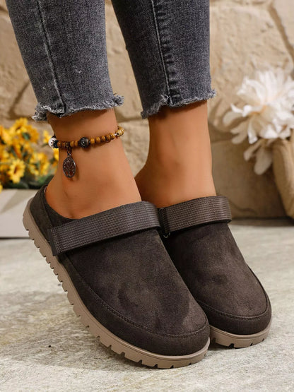 Dark gray round-toe slip-on flats with side strap and grippy rubber outsole