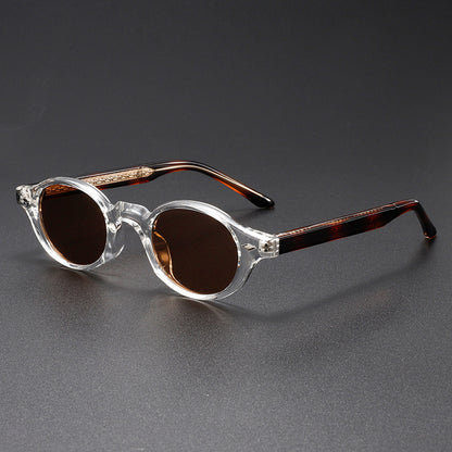 Sunglasses with clear frame and brown lenses on a gray background