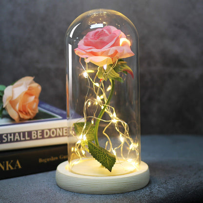 LED rose glass dome lamp with pink rose under clear dome, light beige base