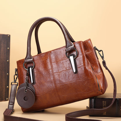 Brown retro large-capacity handbag with top handles, metal hardware, and long crossbody strap