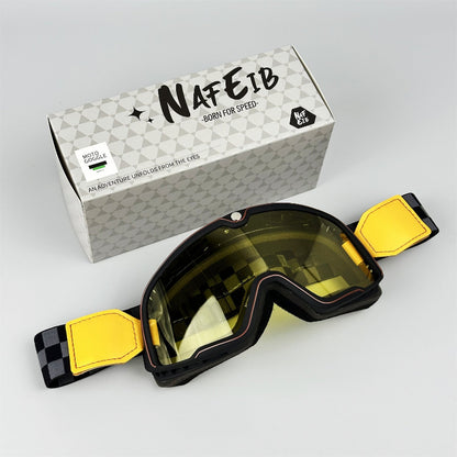 Goggles with yellow straps and a branded box on a light gray background