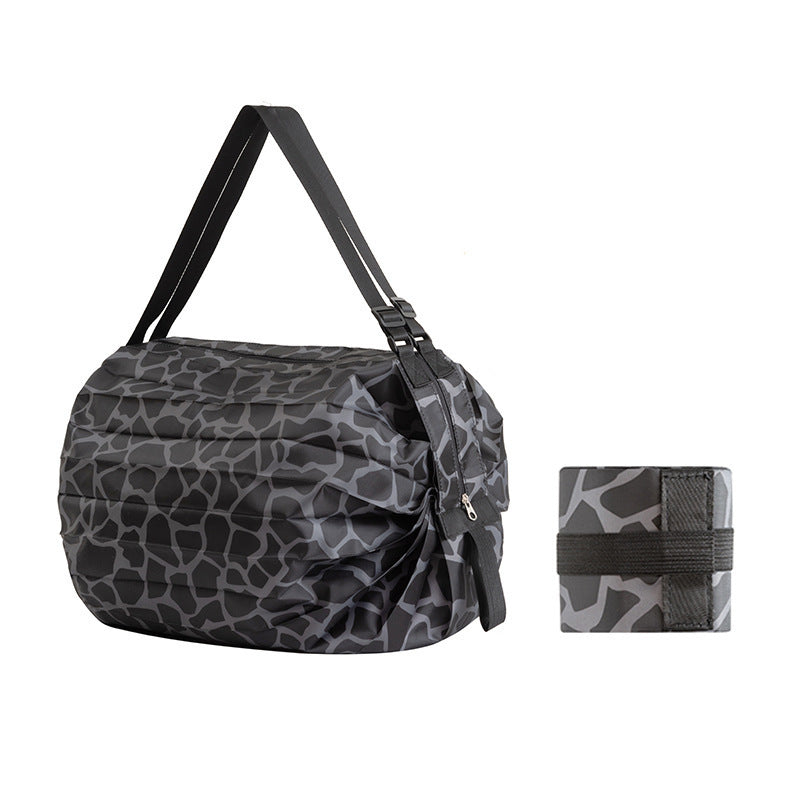 Gray patterned bag and matching wristband on a white background