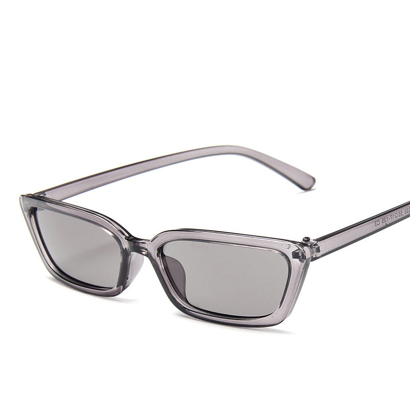 Sunglasses with a transparent frame and dark lenses on a white background