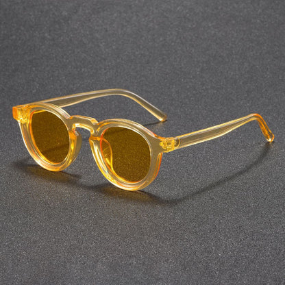 Yellow sunglasses on a gray textured background