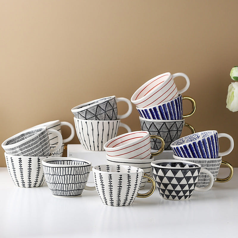 Hand-pinched ceramic mugs, striped and geometric patterns, gold-tone handles