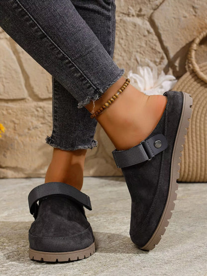 Dark gray suede-like round-toe slip-on flats with side buckle strap and tread sole