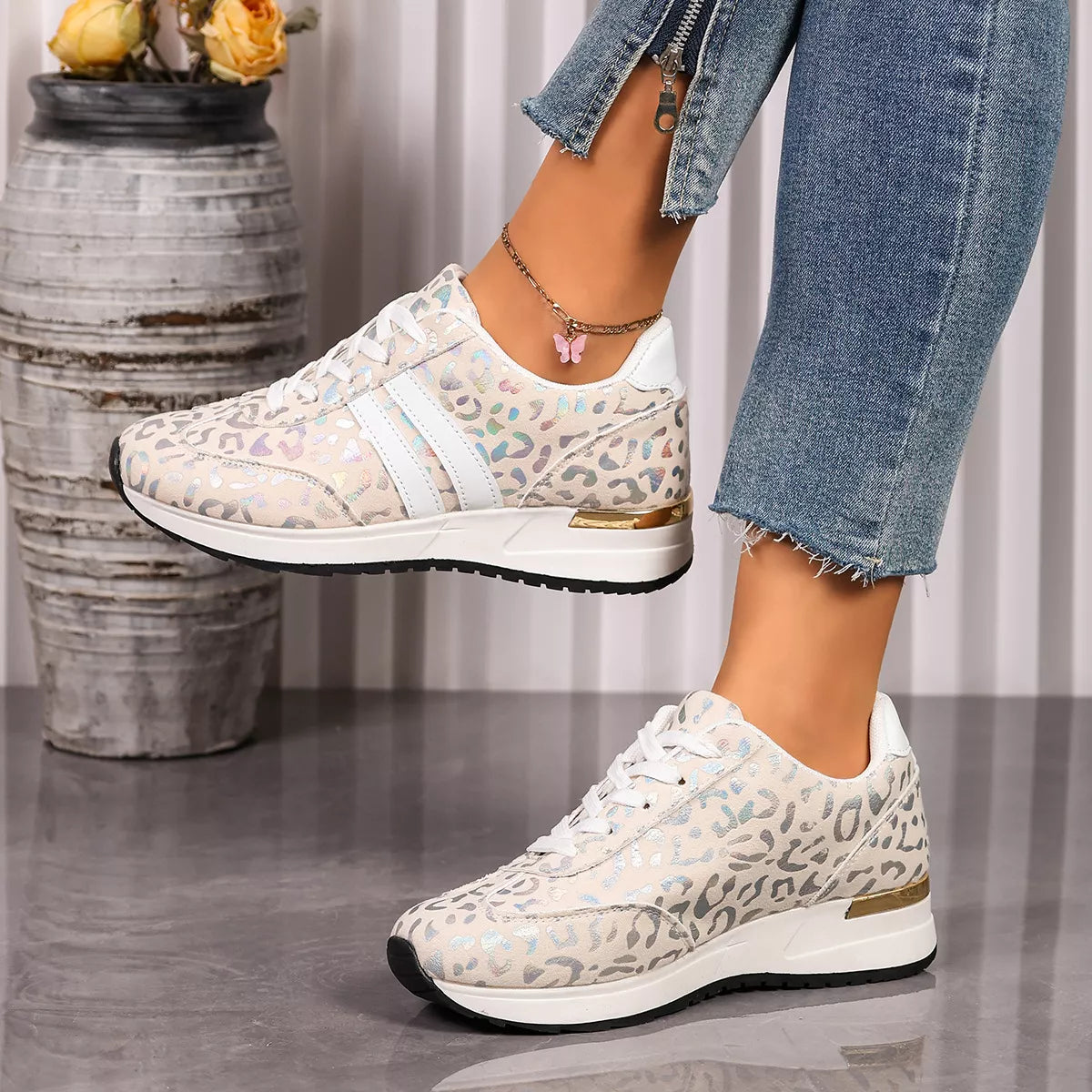 Leopard print lace-up sneakers with white straps and cushioned black sole