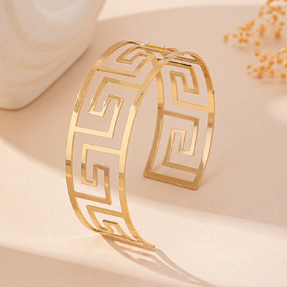 Gold and white bracelet on a beige background