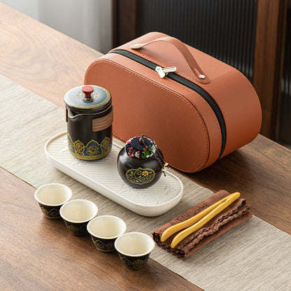 Tea set with ceramic teapot, cups, and accessories on a wooden table.