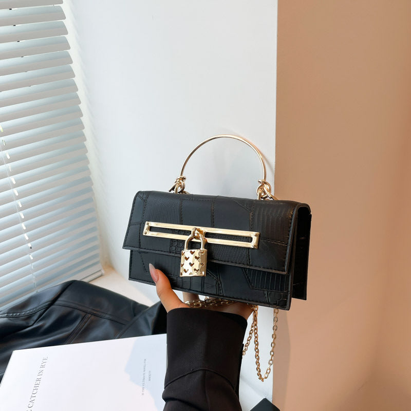 Women’s chain crossbody bag in dark navy PU leather with gold-tone bar clasp and lock