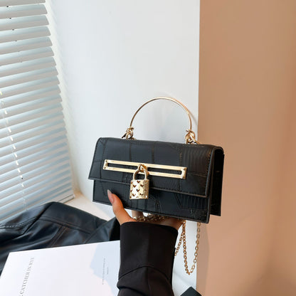Women’s chain crossbody bag in dark navy PU leather with gold-tone bar clasp and lock