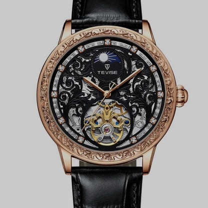 Luxury watch with intricate design and black leather strap on a gray background