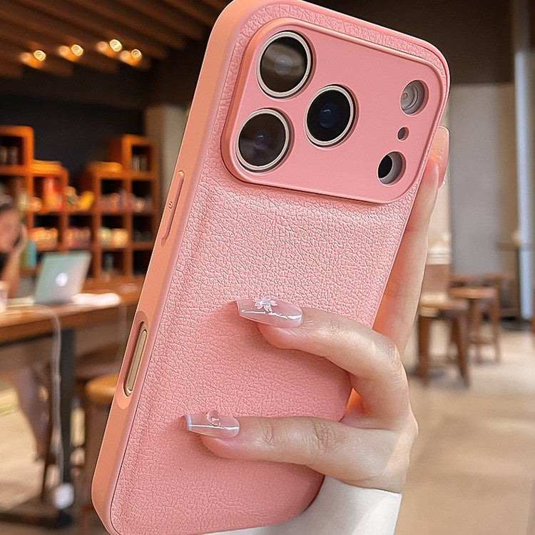 Pink phone case held by a hand in an indoor setting