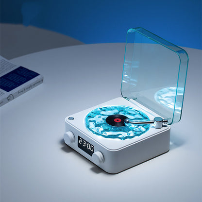 Modern turntable with digital display on a white surface