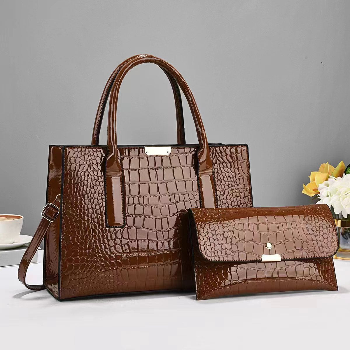 Tote and clutch bag set in brown with croc-texture finish and top handle