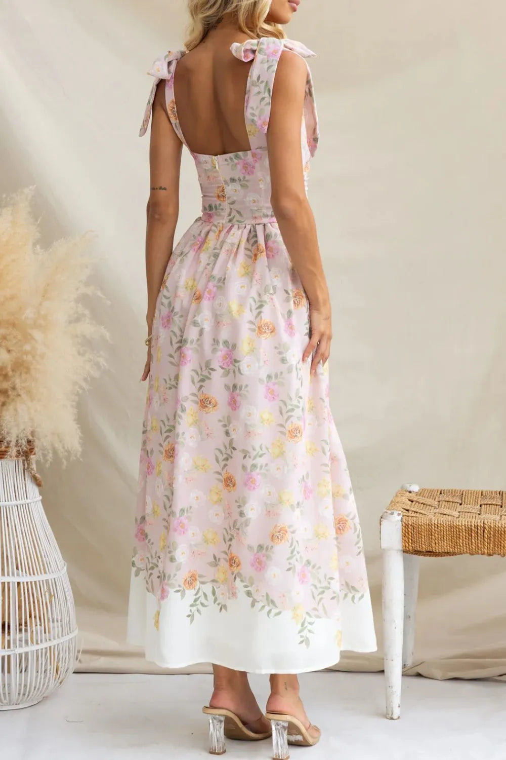 Woman wearing a floral dress with a white background