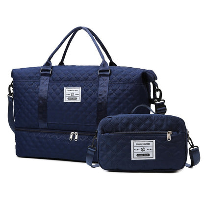 Navy quilted travel bag with shoulder strap and matching crossbody pouch