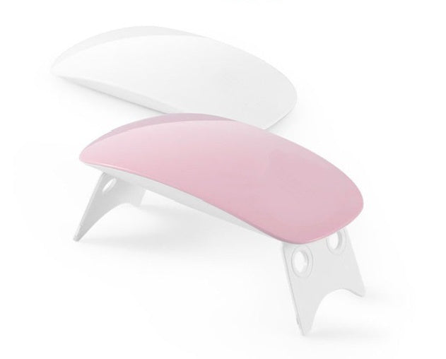 White and pink hair dryer with a nozzle on a white background