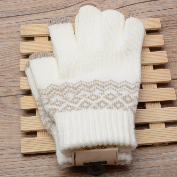Pair of white gloves with a geometric pattern on a wooden surface