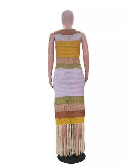 Mannequin wearing a colorful, patterned dress with fringe on a white background