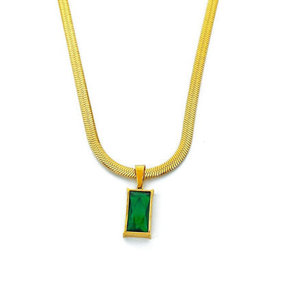 Gold necklace with a green pendant on a white background