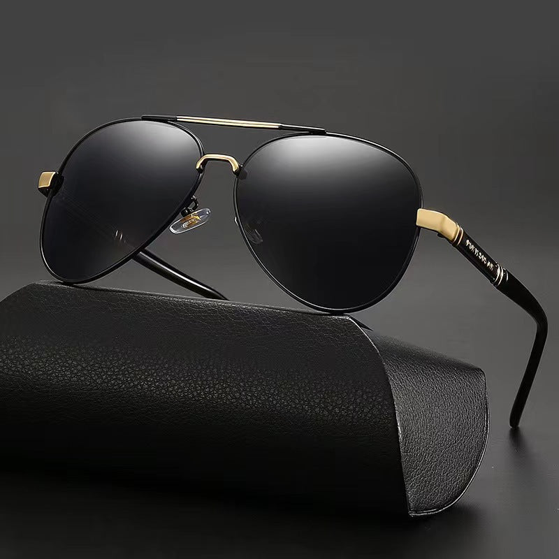 Black sunglasses with gold accents on a black background