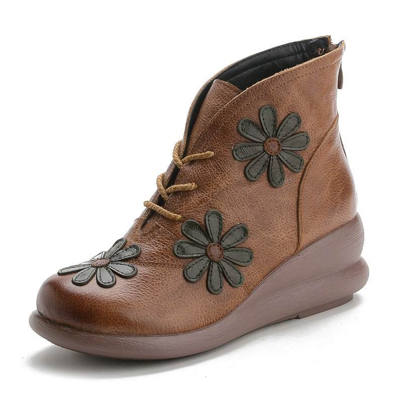 Brown ankle boot with floral designs on a white background