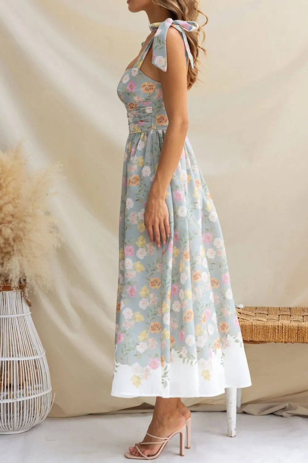 Woman wearing a floral dress with a neutral background