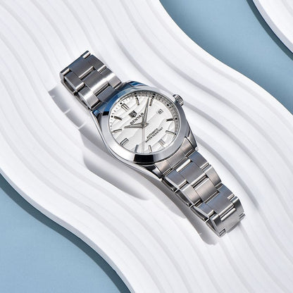 Silver watch with a white face on a white and blue textured background