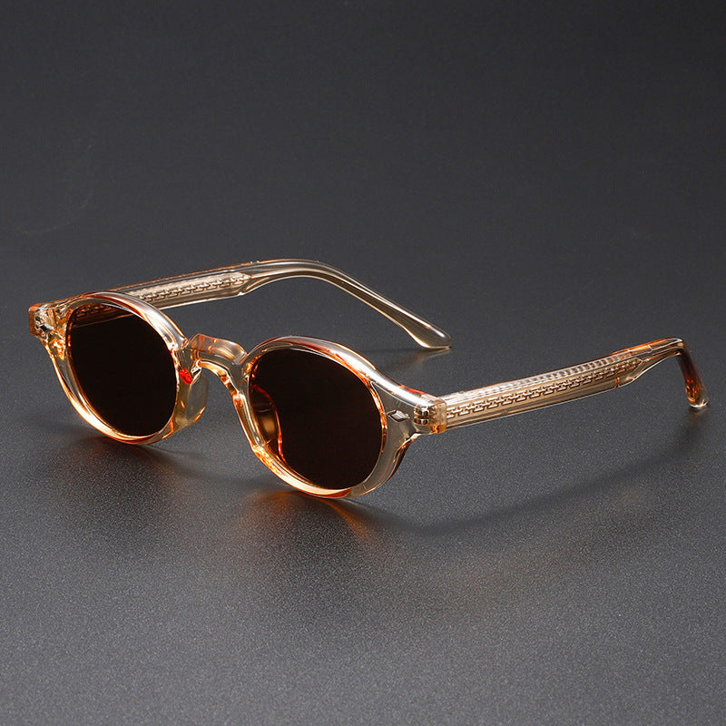 Sunglasses with brown frame and dark lenses on a gray background