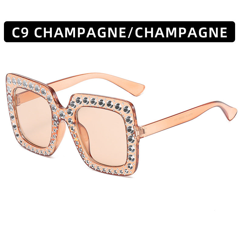 Sunglasses with rose gold frame and embellishments on a white background