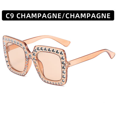 Sunglasses with rose gold frame and embellishments on a white background